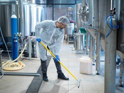 professional cleaning service worker santizing a floor with cleaning equipment