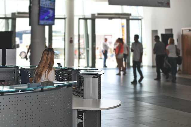 person sitting at a desk in a lobby