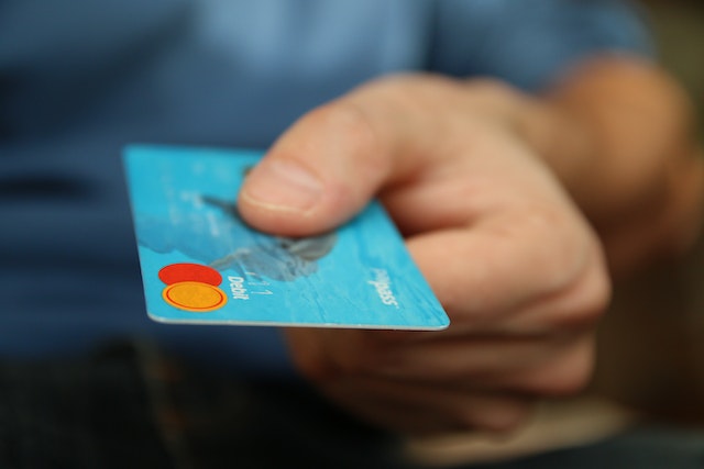 person handing over a credit card