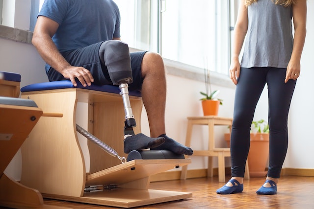 person with prosthetic leg sitting on a bench