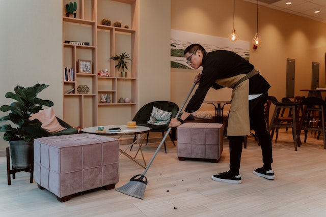 person in cafe sweeping