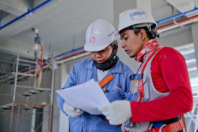 two people in hardhats discussing